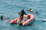 Divers recover the lifeless body of a drowned girl. Image of Divers recover the lifeless body of a drowned girl.