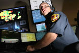 An LAFD dispatcher handles a call. Photo, LA Times. Image of An LAFD dispatcher handles a call. Photo, LA Times.