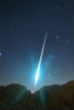 An exceptionally bright Geminid streaks across the sky in this photo. Image of An exceptionally bright Geminid streaks across the sky in this photo.