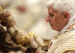 Pope Benedict and the child in the manger on Christmas eve Image of Pope Benedict and the child in the manger on Christmas eve