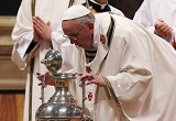 Pope Francis blows on the Oil of Chrism as it is blessed for distribution to the Churches Image of Pope Francis blows on the Oil of Chrism as it is blessed for distribution to the Churches