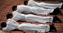 Deacons lie prostrate in submission to God as they are called forth to ordination to the priesthood Image of Deacons lie prostrate in submission to God as they are called forth to ordination to the priesthood