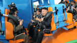 Kim Jong Un prepares to ride a roller coaster, accompanied by his generals. Image of Kim Jong Un prepares to ride a roller coaster, accompanied by his generals.