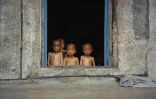Starving children huddled in a window in North Korea. This is typical for those living in the countryside. Image of Starving children huddled in a window in North Korea. This is typical for those living in the countryside.