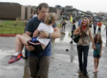 Injured parents walk home after rescuing their children from the destruction at their school where at least 20 other kids perished. Image of Injured parents walk home after rescuing their children from the destruction at their school where at least 20 other kids perished.