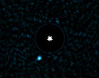 The light of the parent star is blocked out and the planet is the bright blue dot to the lower left. Image of The light of the parent star is blocked out and the planet is the bright blue dot to the lower left.