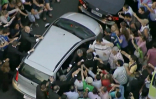 A mob crowds against the Pope's vehicle following his arrival in Rio. Image of A mob crowds against the Pope's vehicle following his arrival in Rio.