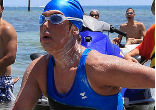 Sunburned and looking dazed, Diana Nyad walked on to the shore. As she approached the beach, spectators waded into waist-high water and surrounded her, taking pictures and cheering her on. Image of Sunburned and looking dazed, Diana Nyad walked on to the shore. As she approached the beach, spectators waded into waist-high water and surrounded her, taking pictures and cheering her on.