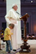 Pope Francis acknowledged the little boy, rubbing his head for a second as the child clings to his side. Image of Pope Francis acknowledged the little boy, rubbing his head for a second as the child clings to his side.