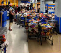 A customer takes a photo of the aftermath, aisles of overstuffed carts left for employees to restock as credit limits and order were restored. Where's the shame? Image of A customer takes a photo of the aftermath, aisles of overstuffed carts left for employees to restock as credit limits and order were restored. Where's the shame?
