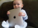 Babies are using iPads before they can form complete sentences. Image of Babies are using iPads before they can form complete sentences.