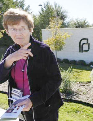 Marian Honquest, an abortion opponent, stands on the sidewalk in front of Planned Parenthood in Fort Worth last week. Marian Honquest, an abortion opponent, stands on the sidewalk in front of Planned Parenthood in Fort Worth last week.