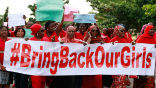 A group of Nigerians holding banners urging the Muslim group Boko Haram to return the more than 200 girls they kidnapped in mid-April. Image of A group of Nigerians holding banners urging the Muslim group Boko Haram to return the more than 200 girls they kidnapped in mid-April.