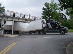 A long island trucker had the top of his semi's trailer sheered off after he hit an overpass that was lower than usual. A long island trucker had the top of his semi's trailer sheered off after he hit an overpass that was lower than usual.