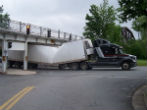 A long island trucker had the top of his semi's trailer sheered off after he hit an overpass that was lower than usual. Image of A long island trucker had the top of his semi's trailer sheered off after he hit an overpass that was lower than usual.