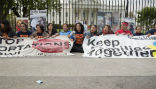 Protestors of U.S. immigration and deportation policy sit with banners outside the White House. Image of Protestors of U.S. immigration and deportation policy sit with banners outside the White House.
