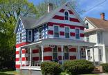 A father of seven foster children painted his house like an American flag after he received nine complains. Image of A father of seven foster children painted his house like an American flag after he received nine complains.