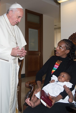 Pope Francis giving a blessing to Meriam and her youngest child Pope Francis giving a blessing to Meriam and her youngest child