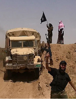 An image made available by the jihadist Twitter account Al-Baraka news on June 11, 2014 allegedly shows militants of the jihadist group Islamic State of Iraq and the Levant (ISIL) waving the Islamic Jihad flag and holding up their weapons as a vehicle drives on a newly cut road through the Syrian-Iraqi border between the Iraqi Nineveh province and the Syrian town of Al-Hasakah. An image made available by the jihadist Twitter account Al-Baraka news on June 11, 2014 allegedly shows militants of the jihadist group Islamic State of Iraq and the Levant (ISIL) waving the Islamic Jihad flag and holding up their weapons as a vehicle drives on a newly cut road through the Syrian-Iraqi border between the Iraqi Nineveh province and the Syrian town of Al-Hasakah.