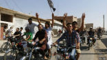 Residents of Raqqa, the capital of the Islamic State, celebrate the capture of a Syrian airbase. Image of Residents of Raqqa, the capital of the Islamic State, celebrate the capture of a Syrian airbase.
