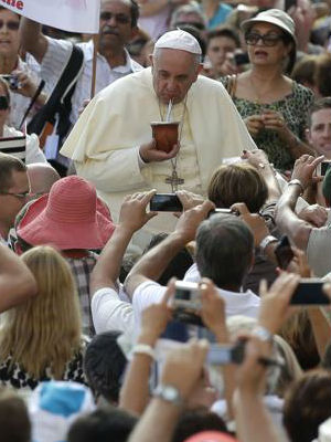 Pope Francis drinks a traditional South American drink called mate offered by the faithful as he arrives to lead his weekly audience in Saint Peter's Square. Pope Francis drinks a traditional South American drink called mate offered by the faithful as he arrives to lead his weekly audience in Saint Peter's Square.