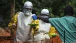 Aid workers in Sierra Leone distribute food to patients infected with Ebola. Image of Aid workers in Sierra Leone distribute food to patients infected with Ebola.