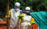 Aid workers provide supplies to an Ebola infected man in West Africa. So far, 2,000 people have been killed by the outbreak that began in early 2014. Image of Aid workers provide supplies to an Ebola infected man in West Africa. So far, 2,000 people have been killed by the outbreak that began in early 2014.