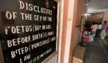 A sign in a hospital in India warns that sex-determination of a child before birth is prohibited under law. Image of A sign in a hospital in India warns that sex-determination of a child before birth is prohibited under law.
