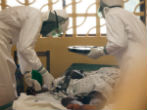 A medical team take care of an Ebola infected boy in Liberia. Image of A medical team take care of an Ebola infected boy in Liberia.