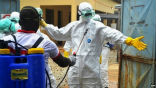 Health workers in Guinea being decontaminated after handling potentially Ebola infected materials. Image of Health workers in Guinea being decontaminated after handling potentially Ebola infected materials.