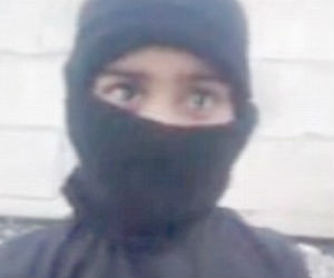 The boy, who appears no older than six, is told to fire the weapon by an adult male who then praises him and encourages him to join in religious chanting. The boy, who appears no older than six, is told to fire the weapon by an adult male who then praises him and encourages him to join in religious chanting.