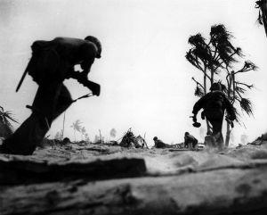 U.S. Marines advance while under fire from Japanese defensive positions. U.S. Marines advance while under fire from Japanese defensive positions.
