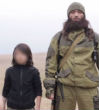 A young boy, no older than 10, is seen shooting two men in ISIS' new video. Image of A young boy, no older than 10, is seen shooting two men in ISIS' new video.