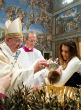 Pope Francis baptizing a child in Rome. Image of Pope Francis baptizing a child in Rome.