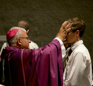 Pictured. A Bishop placing ashes on the head of a penitent on Ash Wednesday Pictured. A Bishop placing ashes on the head of a penitent on Ash Wednesday