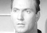 Looking befuddled in a spaceship full of ladders and ancient radio equipment, lead actor Gregory Walcott foreshadows the world's reaction to Image of Looking befuddled in a spaceship full of ladders and ancient radio equipment, lead actor Gregory Walcott foreshadows the world's reaction to