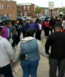 A prayer circle forms amidst the Baltimore riot destruction. (Deborah Weiner/WBAL-TV) Image of A prayer circle forms amidst the Baltimore riot destruction. (Deborah Weiner/WBAL-TV)