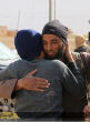 The ISIS militants are photographed hugging the blindfolded accused gay men. Image of The ISIS militants are photographed hugging the blindfolded accused gay men.