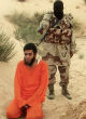 An Islamic State fighter, about to execute an Egyptian man accused of spying for Israel. Image of An Islamic State fighter, about to execute an Egyptian man accused of spying for Israel.