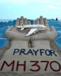 A sand sculpture urging all to pray for MH370. Image of A sand sculpture urging all to pray for MH370.