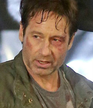 Whether it was aliens of 'men in black,' photos show actor David Duchovny worse for wear with his brown hair mussed and hanging in sweaty ringlets, a blackened eye, and a face covered with stubble and abrasions Whether it was aliens of 'men in black,' photos show actor David Duchovny worse for wear with his brown hair mussed and hanging in sweaty ringlets, a blackened eye, and a face covered with stubble and abrasions