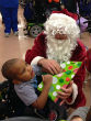 Boy opens gift at the Louisiana Special Education Center (Leigh Guidry). Image of Boy opens gift at the Louisiana Special Education Center (Leigh Guidry).
