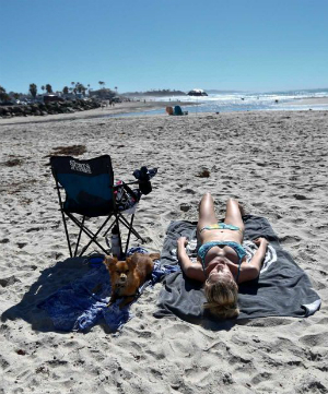 Californians are making the most of the unseasonable weather, sunbathing on the beaches as rain falls far to the north of Los Angeles. Californians are making the most of the unseasonable weather, sunbathing on the beaches as rain falls far to the north of Los Angeles.