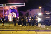 Milwaukee police hold a standoff with protesters following a fatal police shooting. Image of Milwaukee police hold a standoff with protesters following a fatal police shooting.