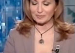 Italian newscaster criticized for wearing crucifix and rosary beads on air. Image of Italian newscaster criticized for wearing crucifix and rosary beads on air.