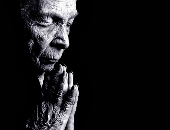 Old woman in persevering prayer Old woman in persevering prayer
