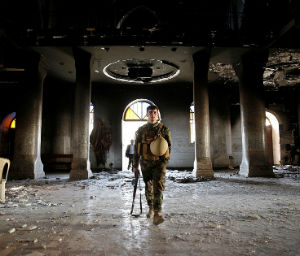 Christian citizens and troops entered the damaged Church to practice Mass (Reuters). Christian citizens and troops entered the damaged Church to practice Mass (Reuters).