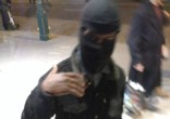 Masked man revealed an ISIS flag and beheading video on his phone (InfoWars). Image of Masked man revealed an ISIS flag and beheading video on his phone (InfoWars).