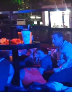 Blue Parrot nightclub patrons huddle under tables as shots ring out (Marcos Vazquez/Twitter). Blue Parrot nightclub patrons huddle under tables as shots ring out (Marcos Vazquez/Twitter).