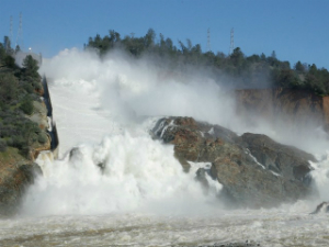 Water rushes down the spillway and into the eroded area outside the dam. Erosion is threatening the integrity of the system and up to a quarter million people could be affected. Water rushes down the spillway and into the eroded area outside the dam. Erosion is threatening the integrity of the system and up to a quarter million people could be affected.